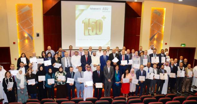 A group shot of people, some wearing Arabic clothing, holding accreditation certificates 