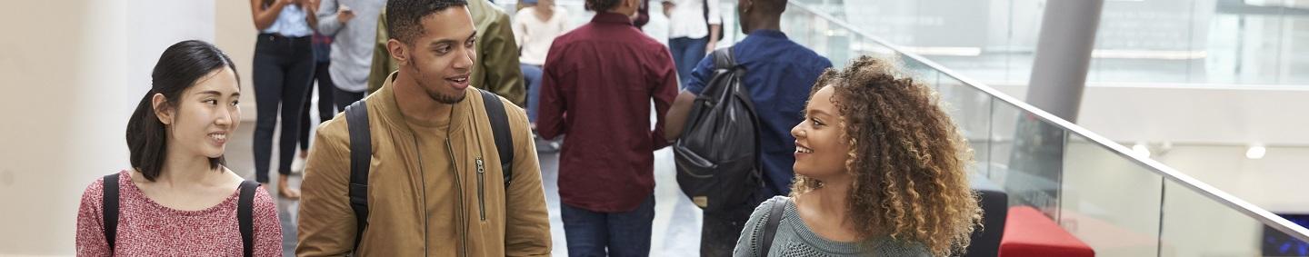 Students walking through university lobby