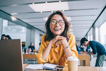 Student in library smiling