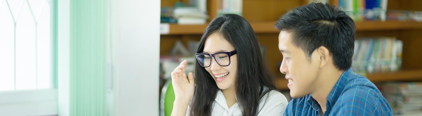 Two students working in library