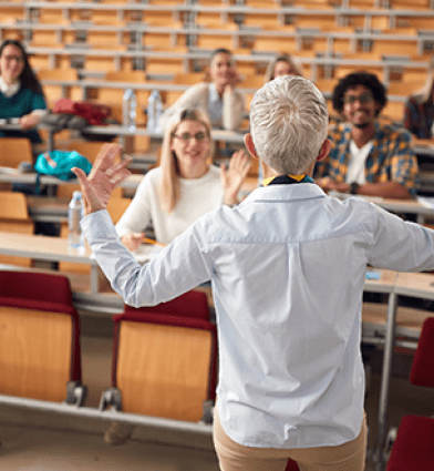 Students looking at female professor